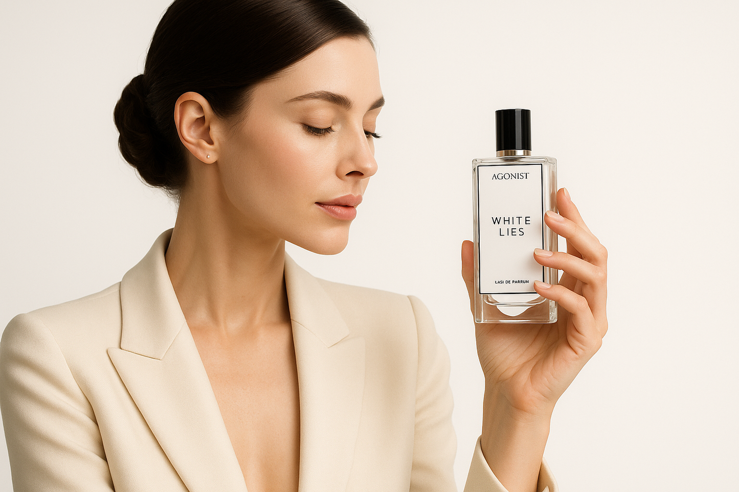 sexy girl holding and looks like admiring bottle of Agonist White Lies fragrance